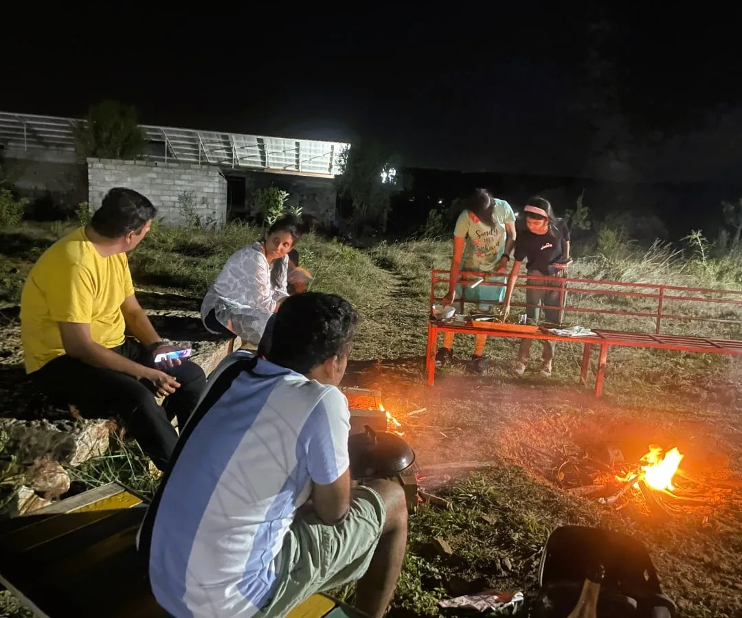 A family gathered around the evening campfire