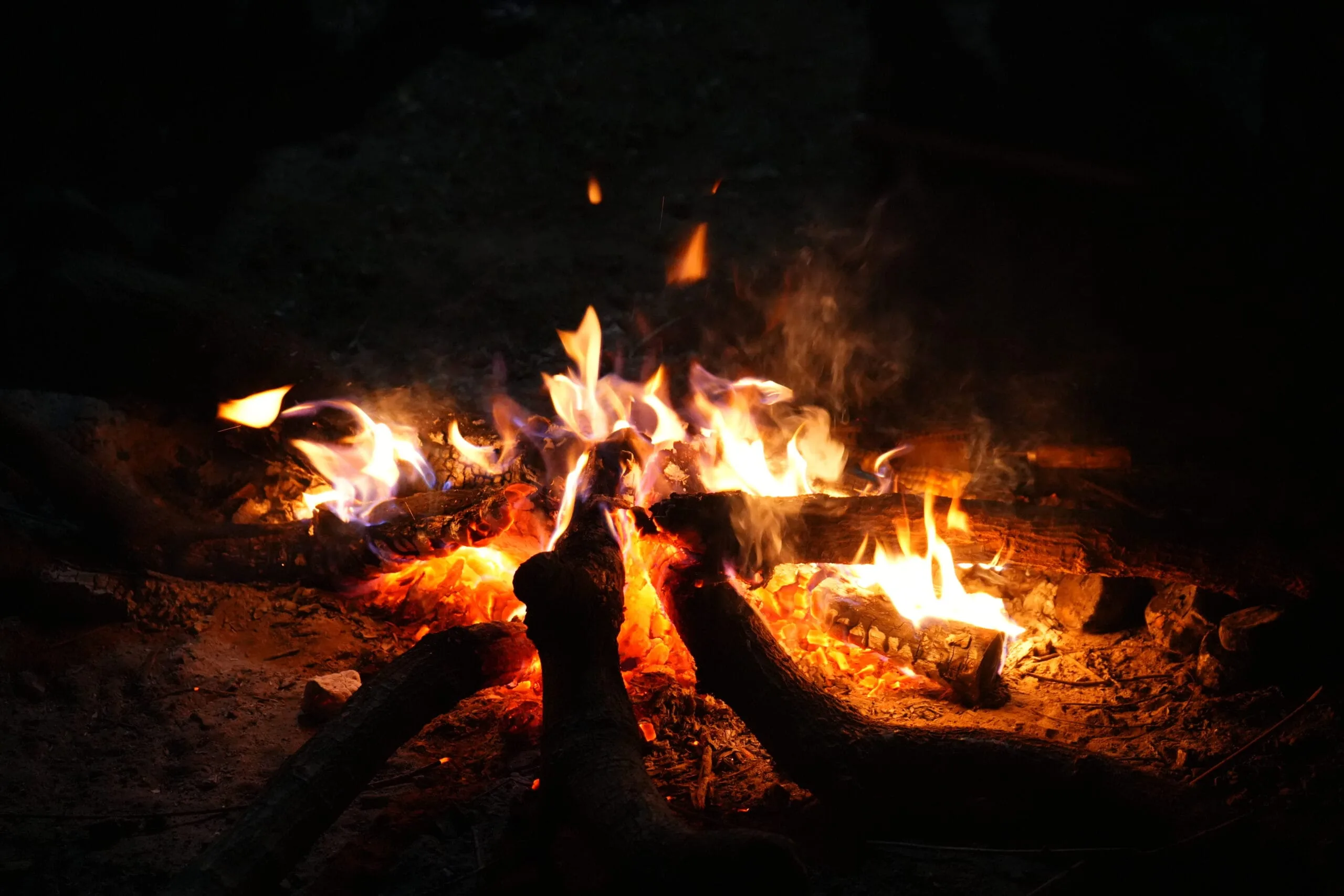 A campfire burning after dark at the farm