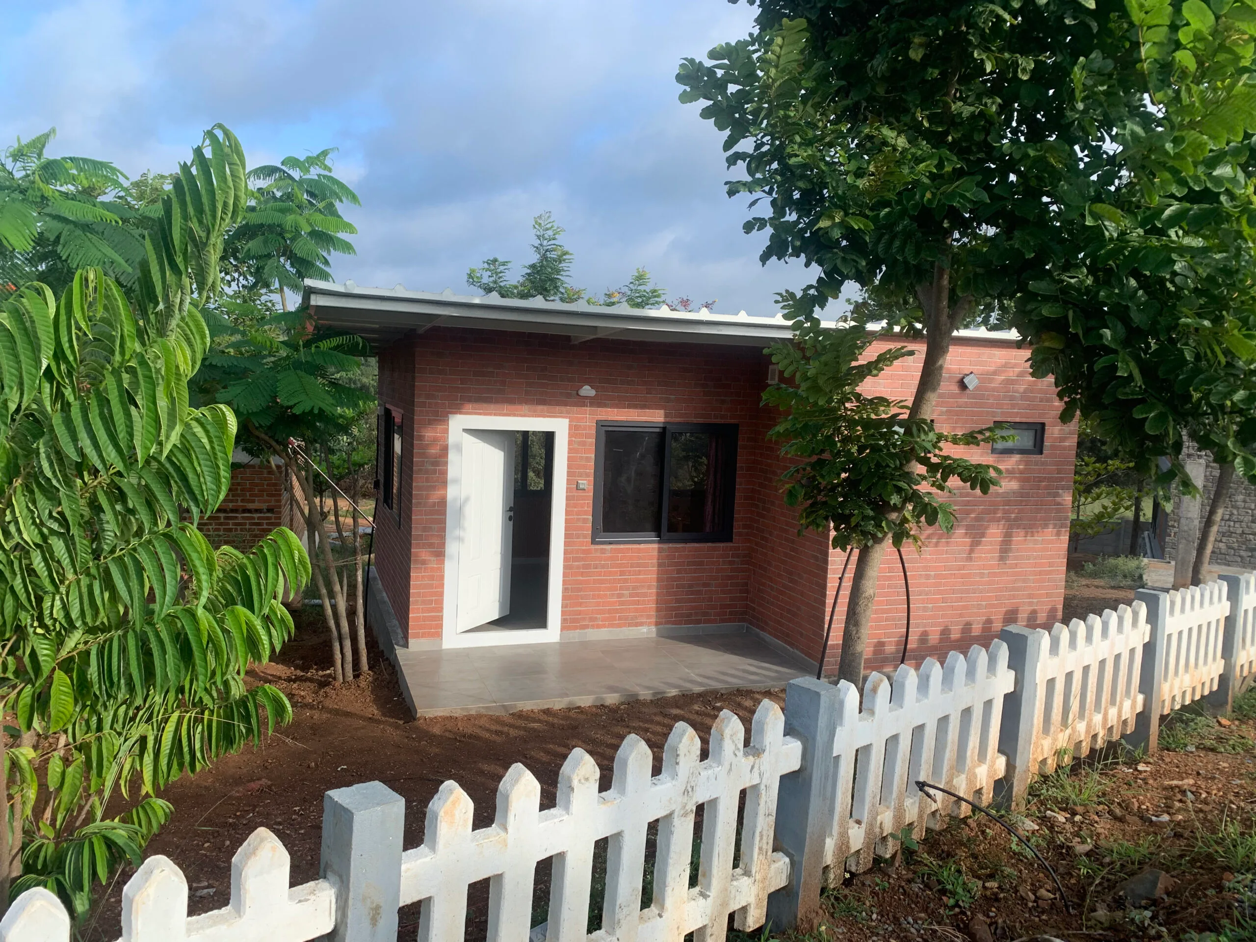A brick cottage at the edge of the farm