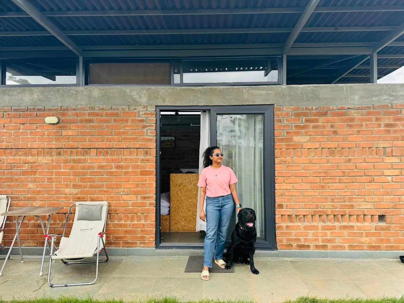 A guest sitting with the farm's black dog